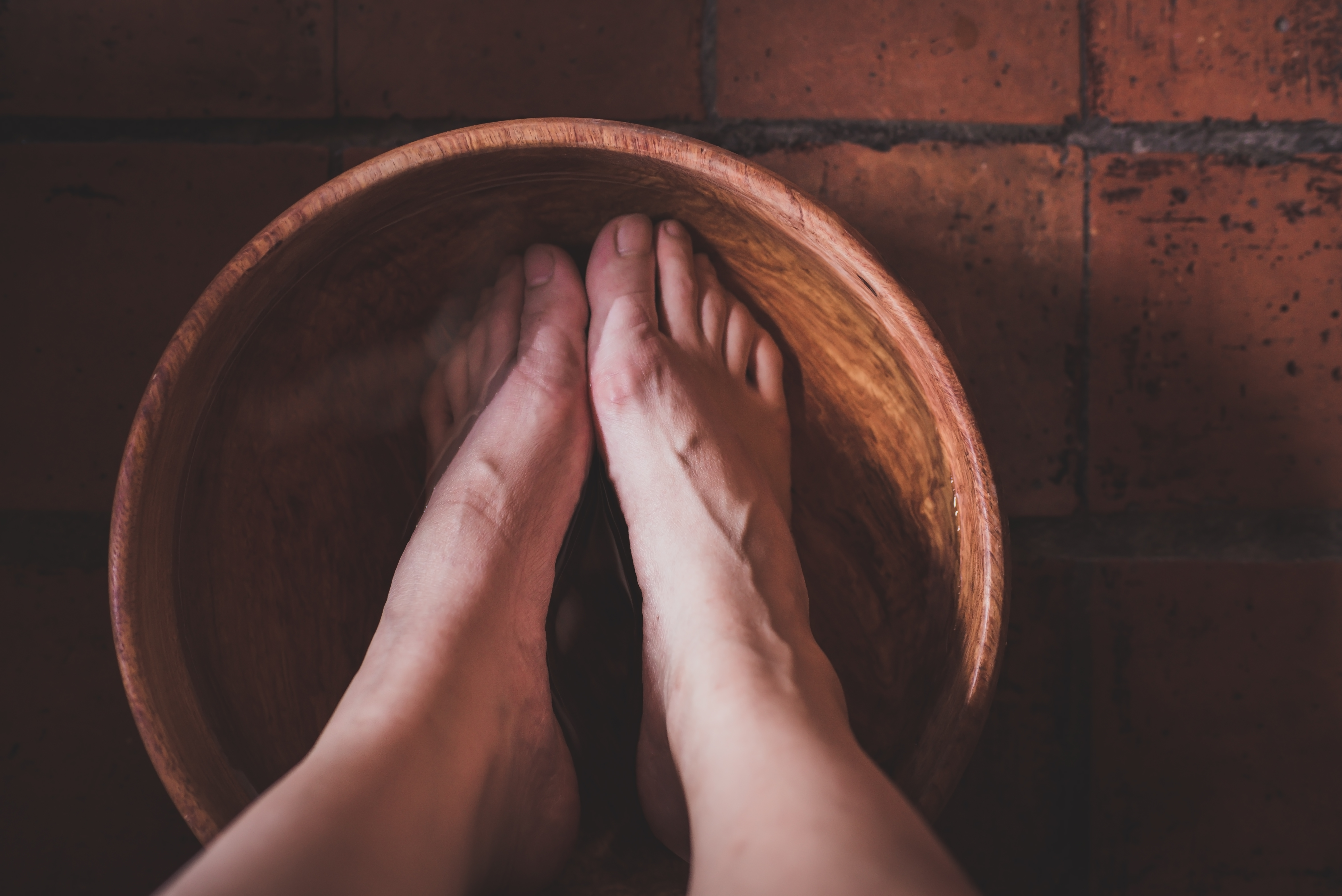 foot bath in a wooden bowl preparing for reflexology